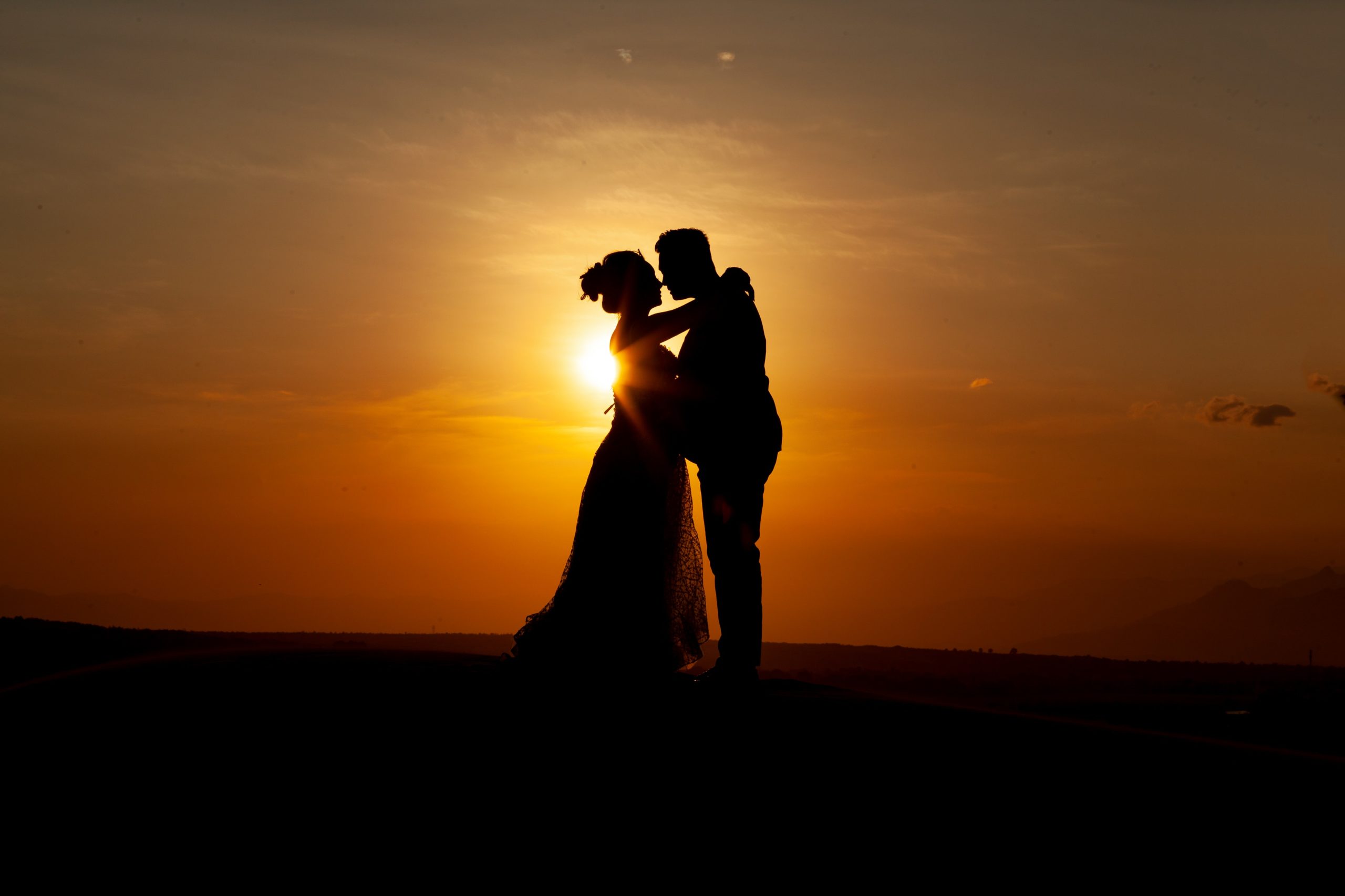 silhouette-of-couple-kissing-during-sunset-3998366